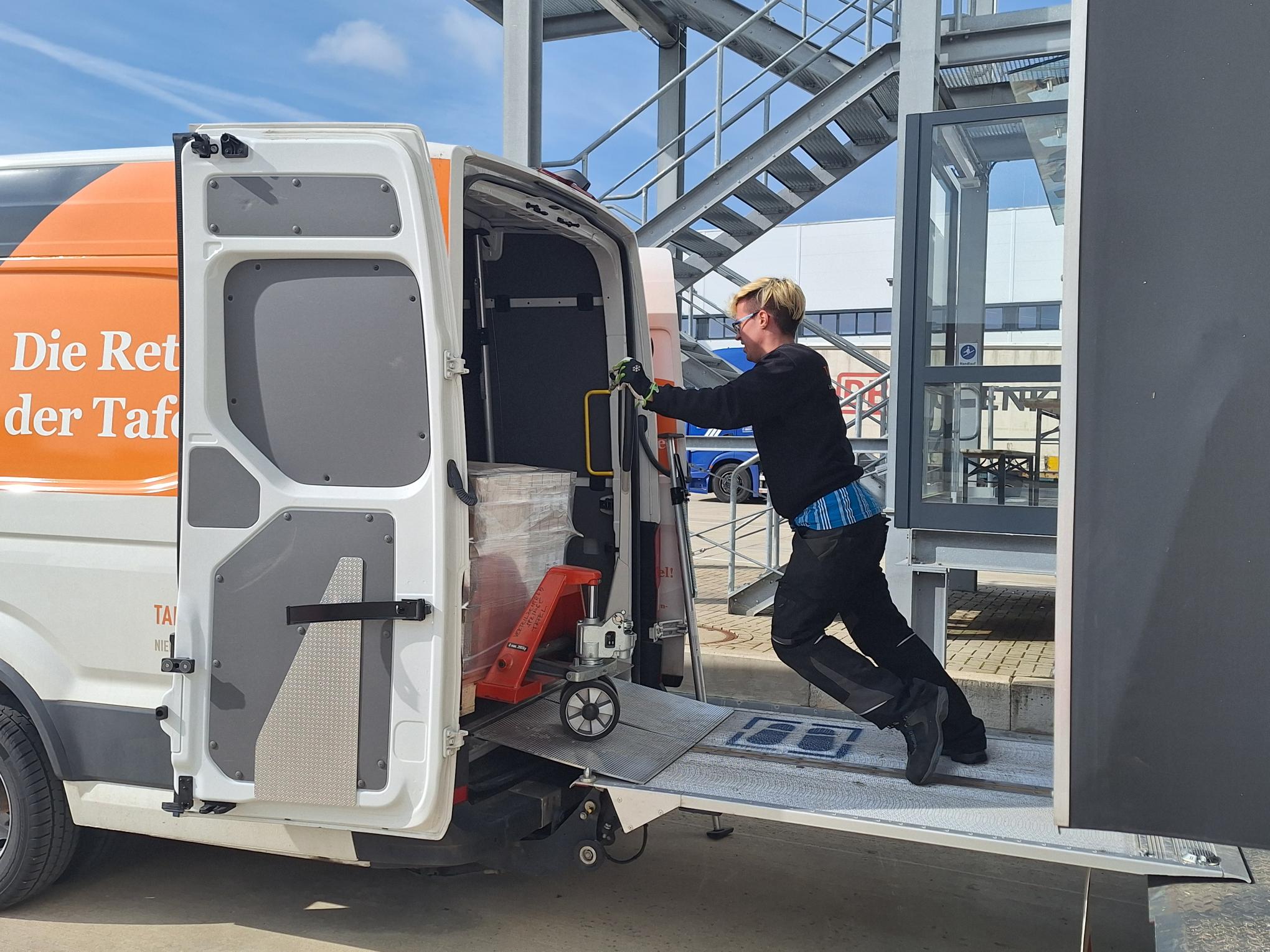 Frau schiebt Palette in einem Bully