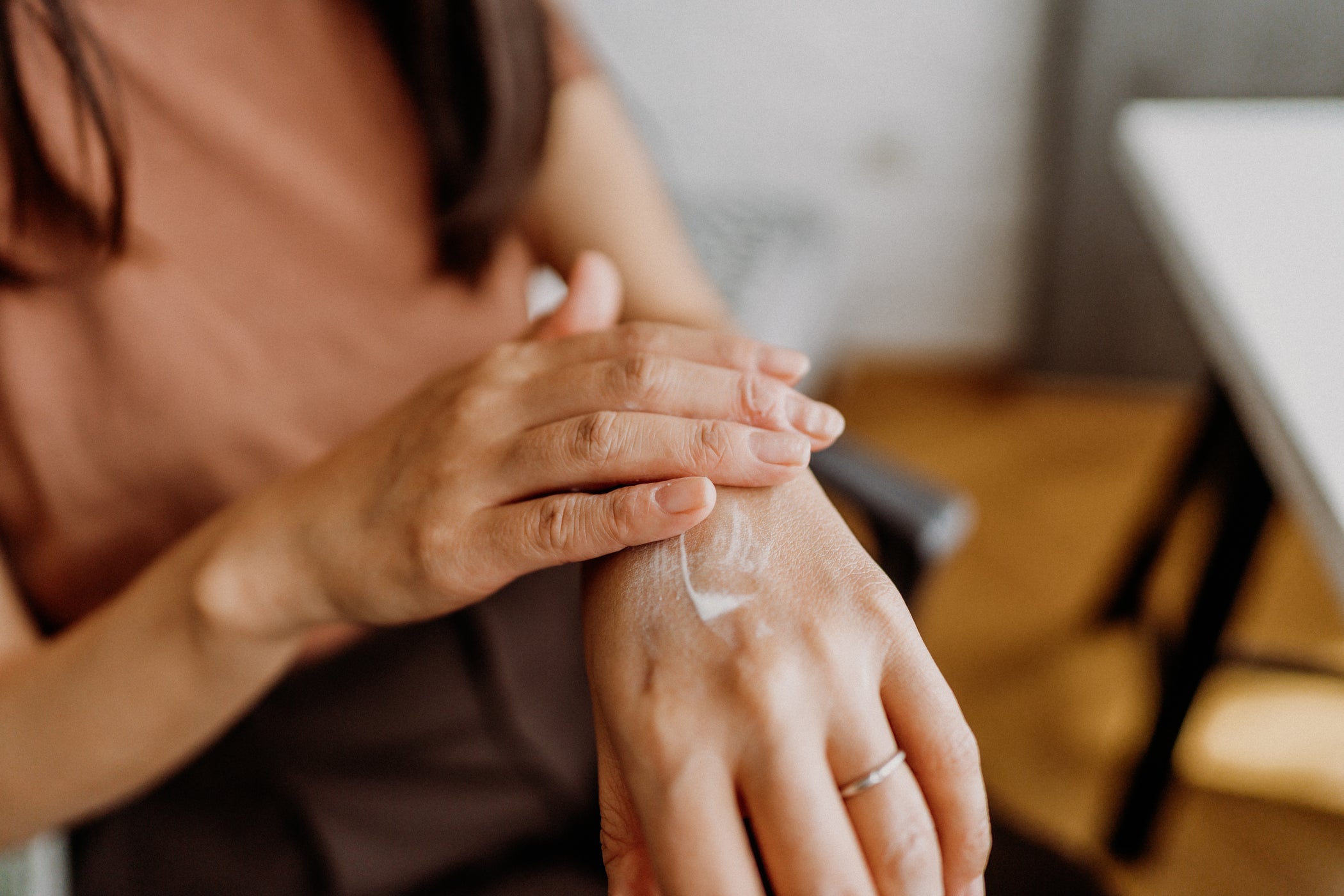 Gros plan : femme applique crème pour les mains sur le dos de la main, soin quotidien
