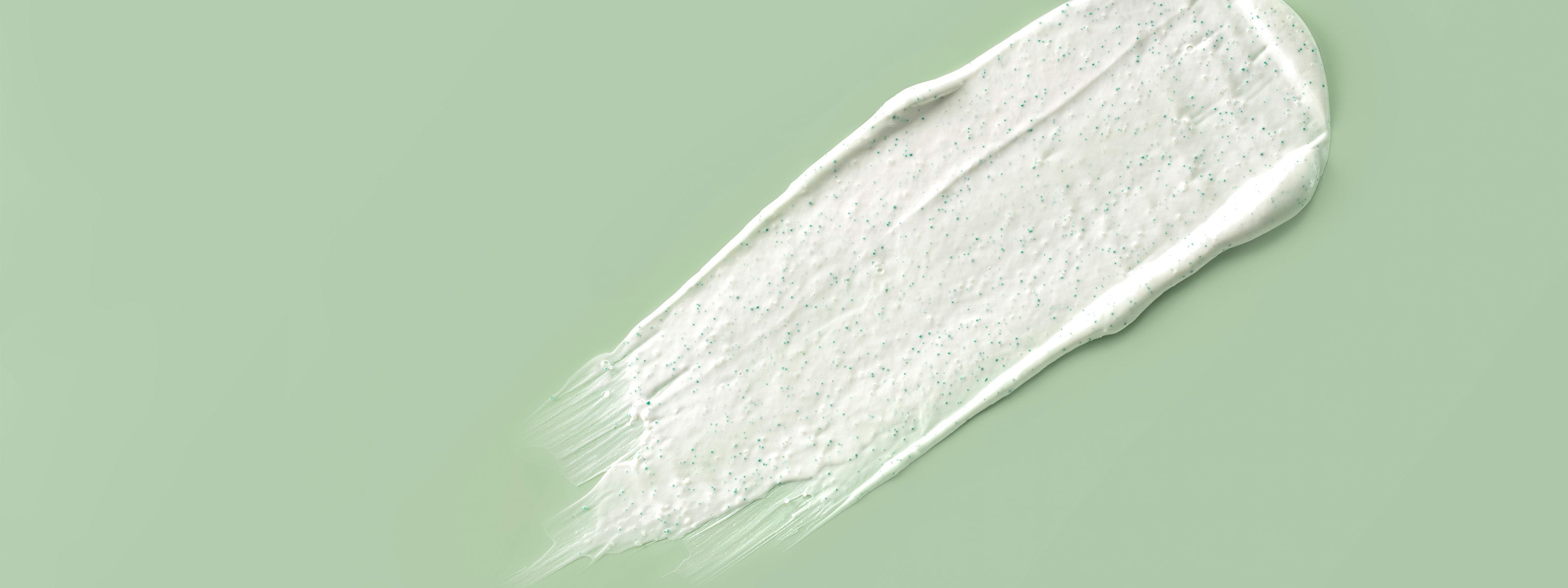 Texture de crème sur fond vert